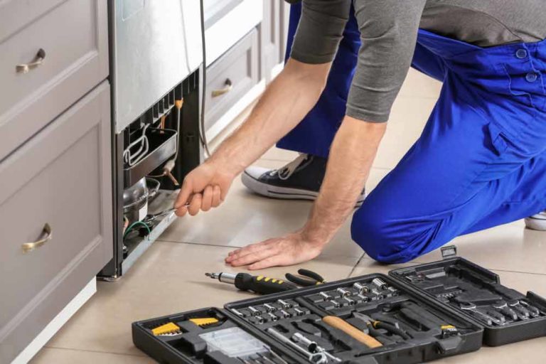 Technician Repairing Refrigerator Indoors — Instachill in Gold Coast, QLD