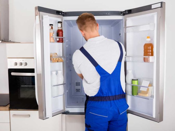 Technician Fixing A Refrigerator — Instachill in Gold Coast, QLD