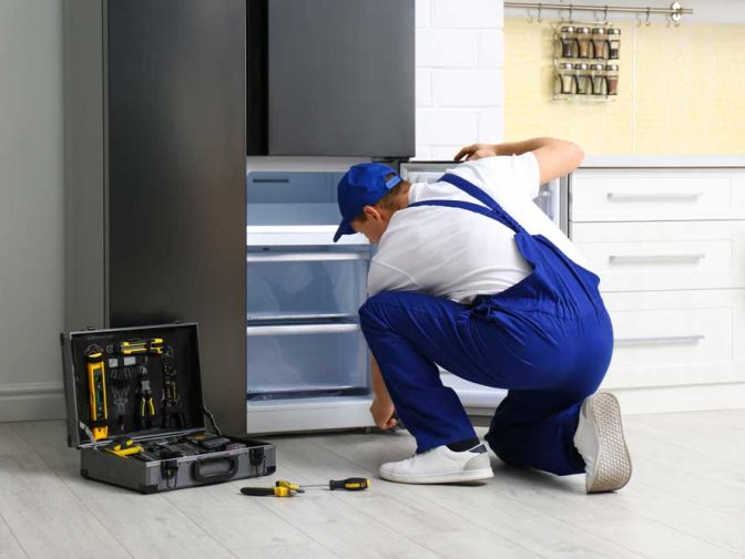 Technician Repairing A Broken Refrigerator — Instachill in Gold Coast, QLD