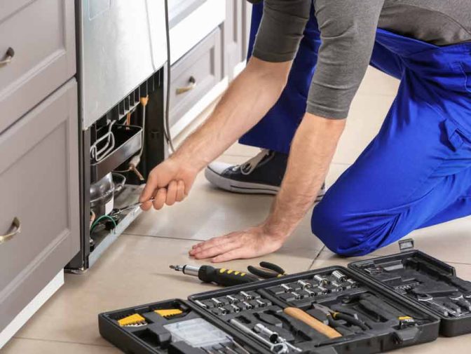 Technician Repairing Refrigerator Indoors — Instachill in Gold Coast, QLD
